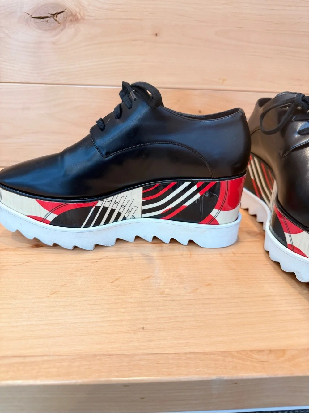 Stella McCartney Black Leather Elyse Platform Shoes with abstract design.